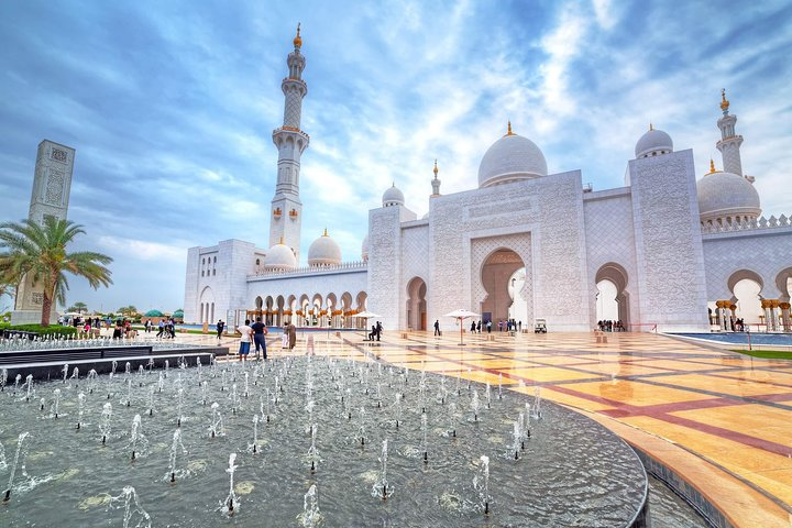 Discover the stunning architecture of the Sheikh Zayed Grand Mosque where intricate designs meet serene water features offering a perfect backdrop for memorable photography and cultural exploration.